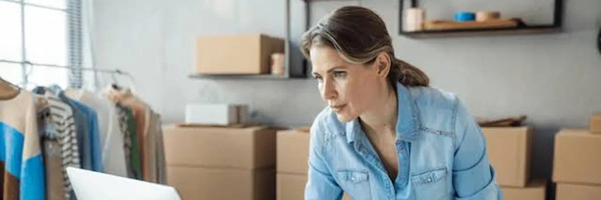 Small business owner reviewing employee benefits costs at her desk